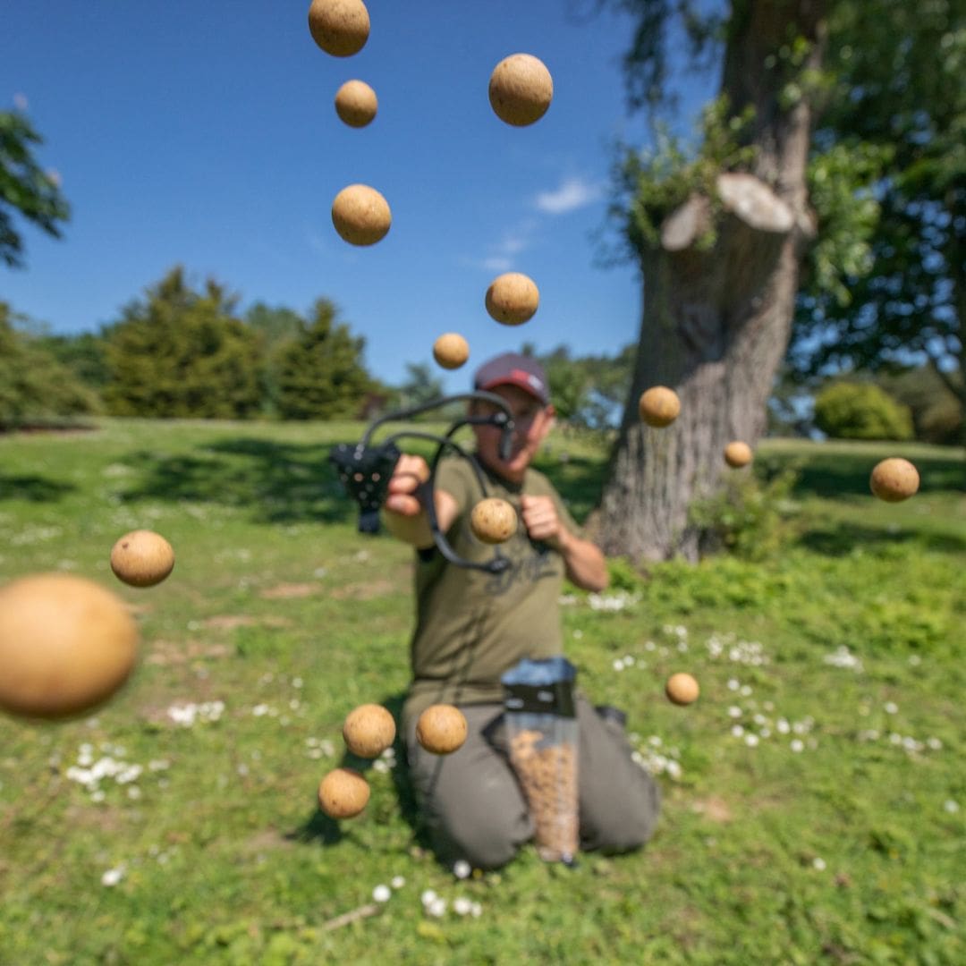 Angler Catapulting Carp Boilies