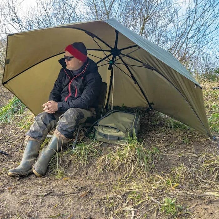 Fishing Umbrella With Sides Man sitting under a Fishing Umbrella With Sides