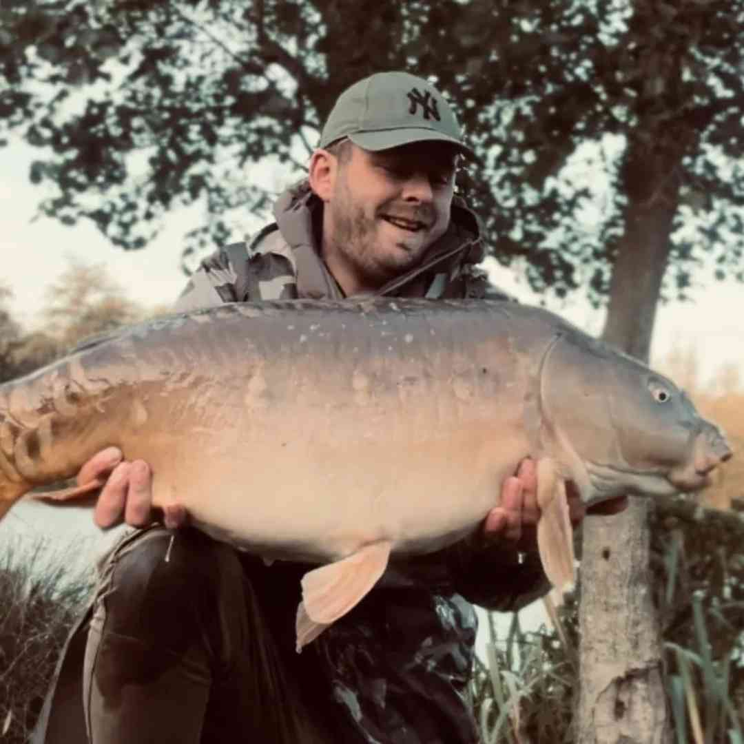 Angler Holding a Record-Breaking Carp