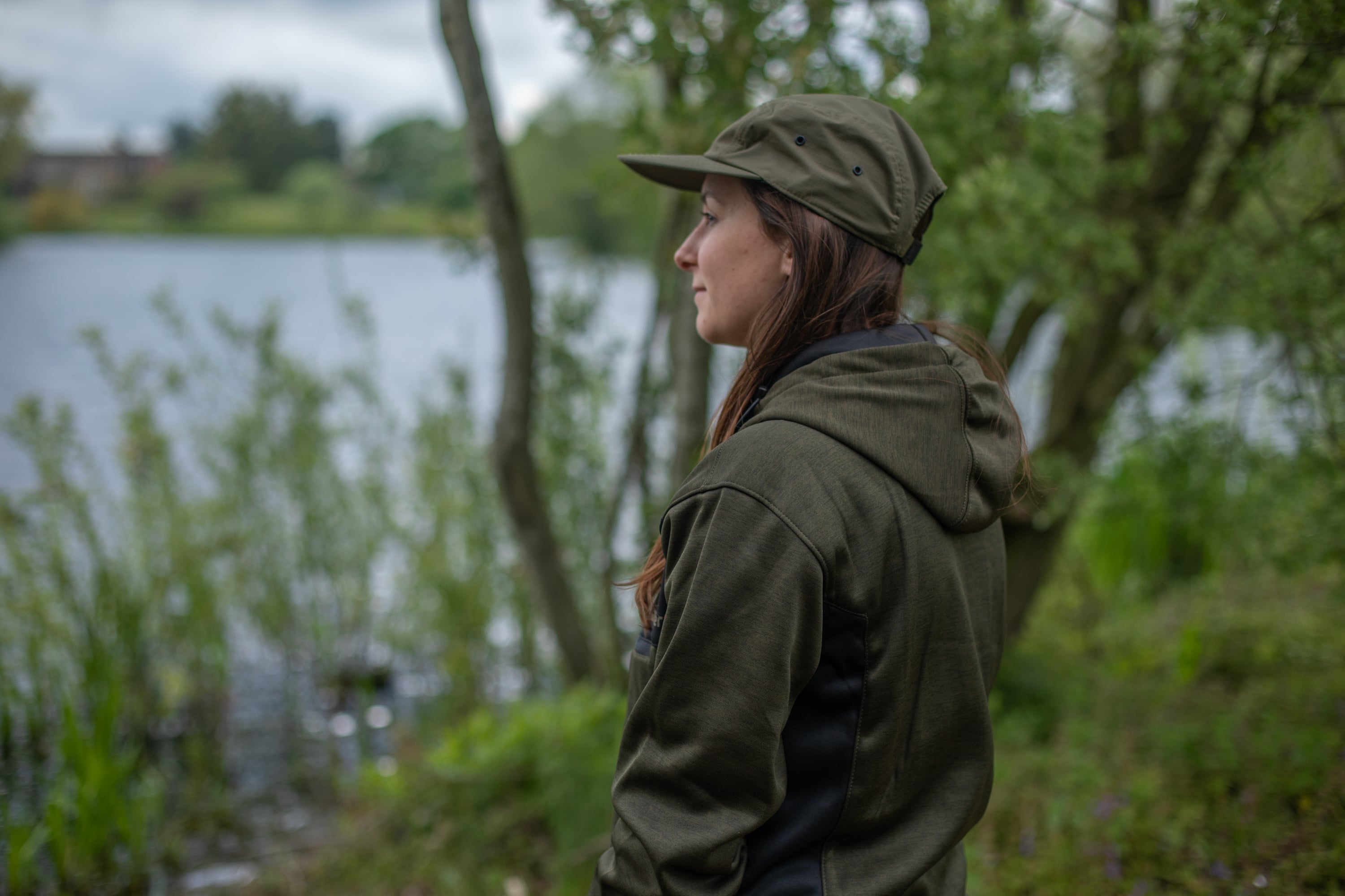 Woman with fishing cap, at the bankside
