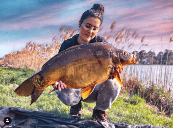 Flora with her carp catch - Image is taken from CarpCrossingGirls.com